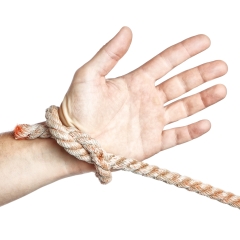 Man's hand tied  limitation with a rope. On a white background.
